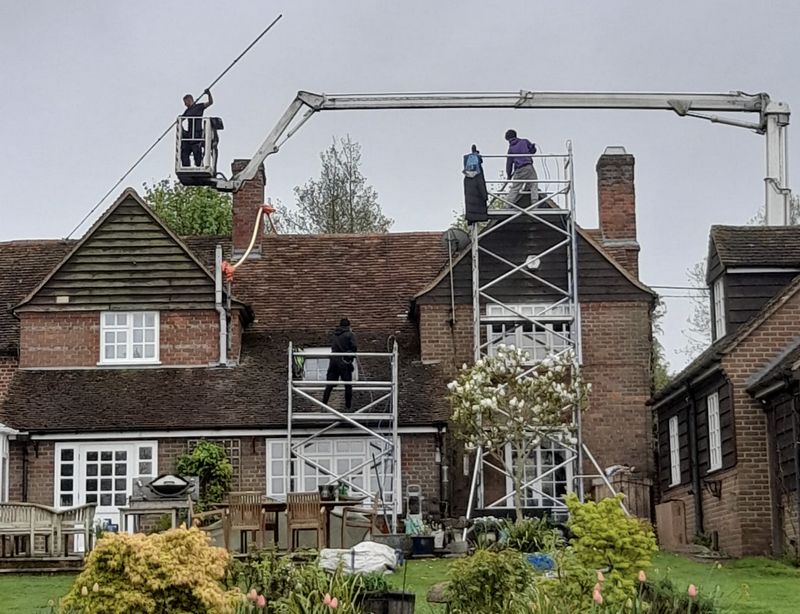 The Moss Cleaners using cherry picker and scaffolding to clean roof safely and professionally in Wilton, Wiltshire